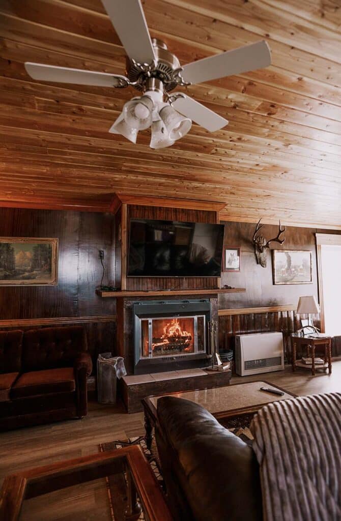 The wood fire burning in the hearth at Foreman’s Cabin