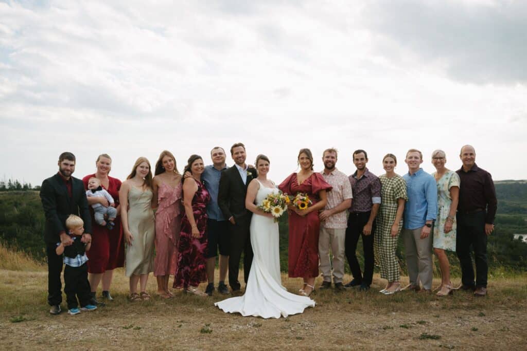 The wedding party gathered on the grass at Blue Sky Ranch