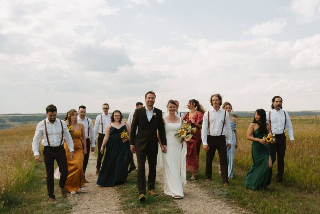 The wedding party gathered on the grass at Blue Sky Ranch