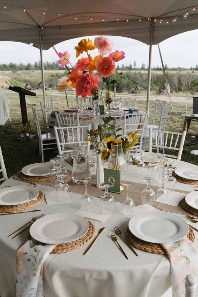 A golden retriever walks the aisle at an outdoor wedding ceremony, Blue Sky Ranch wedding