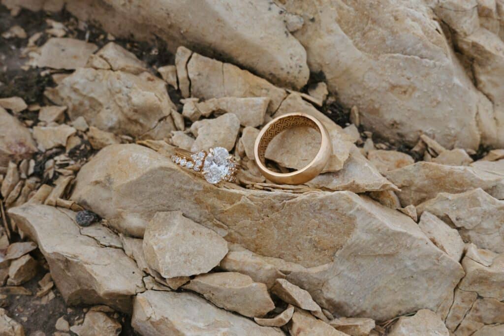 Two wedding rings resting on the quarried stone at Blue Sky Ranch
