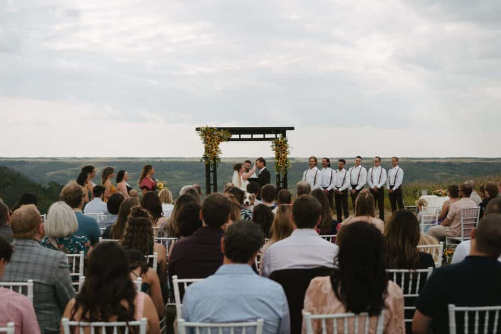 Guests seated for an outdoor wedding ceremony on the ravine edge, Blue Sky Ranch wedding